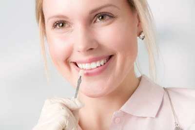 woman choosing dental veneers color at Olympia Advanced Dentistry