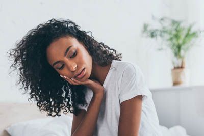 woman needing an emergency dentist in Olympia, WA