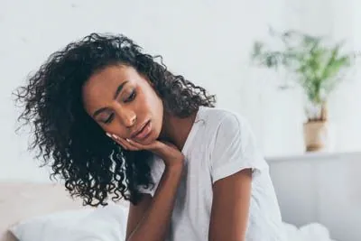 woman needing an emergency dentist in Olympia, WA