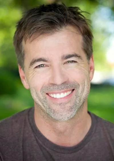 man smiling after cosmetic dentistry treatment at Olympia Advanced Dentistry