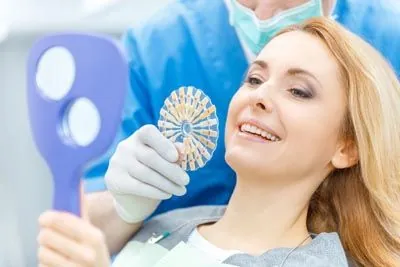 woman picking a color for dental veneers in Olympia, WA