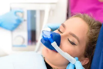 woman sleeping during her procedure at Olympia Advanced Dentistry