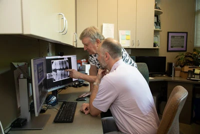 Dr. Moss and Dr. Isaacson discussing restorative dental care