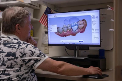 Dr. Isaacson reviewing a dental X-ray at Olympia Advanced Dentistry