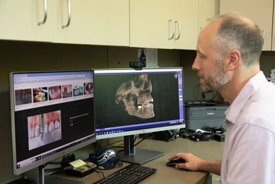 Dr. Moss reviewing X-rays for restorative dental care