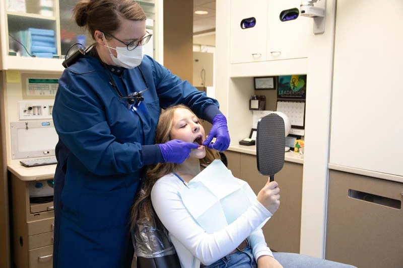 A female patient with a staff memeber for a periodontal therapy and exam in olympia wa dentist