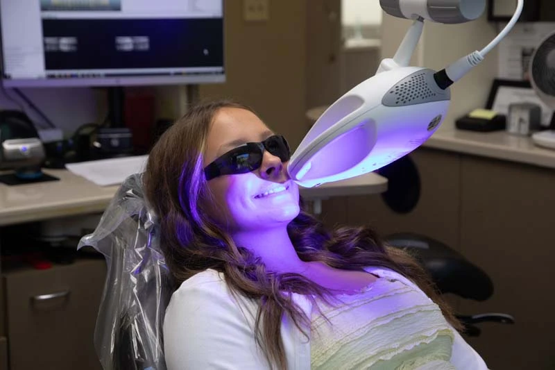 Female patient undergoing the zoom teeth whitening process at Olympia Advanced Dentistry