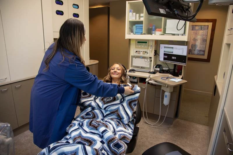 A female patient receiving a blanket before a dental exam at Olympia Advanced Dentistry in WA.