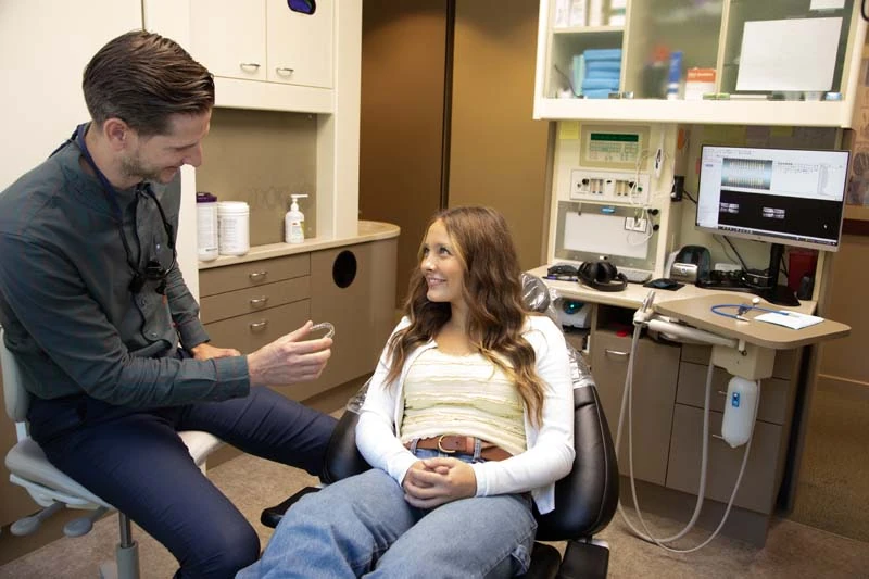 Young female patient speaking with Dentist Dr. Tyler Tebay at Olympia Advanced Dentistry