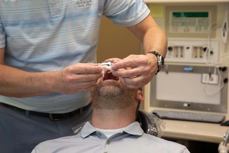 Dr Joseph Moss, DDS discuss tmj treament options with a male patient at Olympia Advanced Dentistry in Olympia WA
