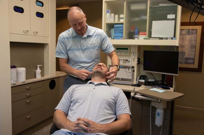 Dr Joseph Moss, DDS discuss tmj treament options with a male patient at Olympia Advanced Dentistry in Olympia WA