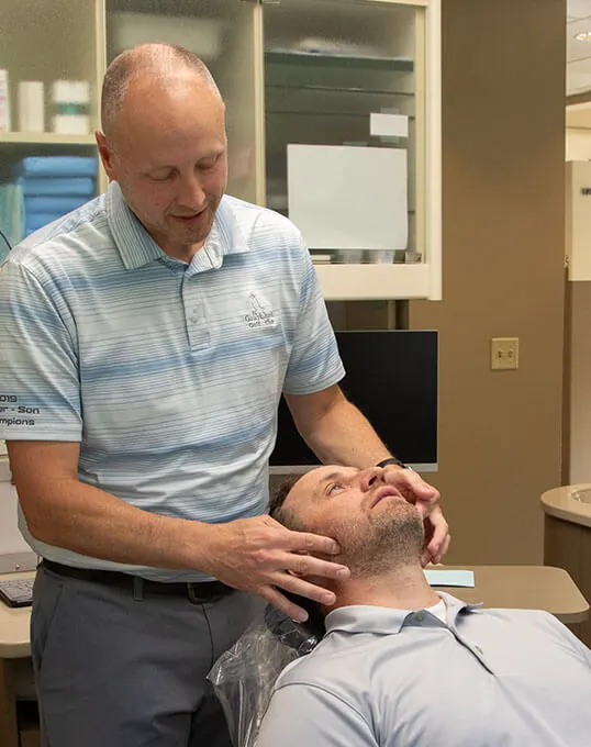 Dr. Joseph Moss reviewing TMJ treatment options with a patient.
